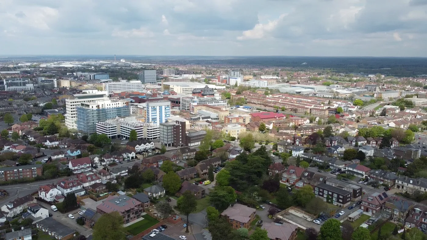 Slough town centre from the air, with the office blocks around the station and the High Street beyond